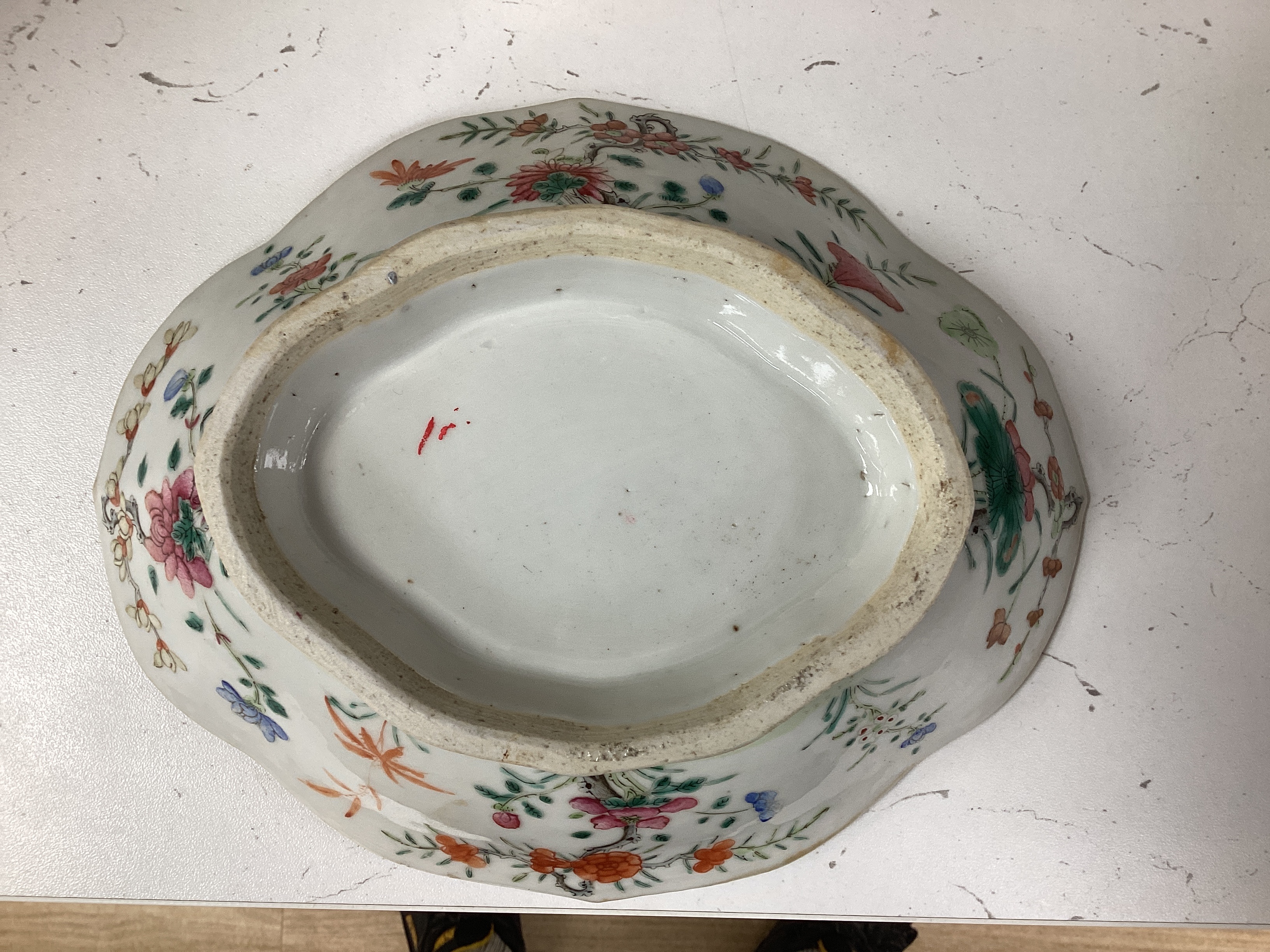 A 19th century Chinese blue and white ingot shaped dish and a famille rose footed dish, the largest 25cm wide (2)